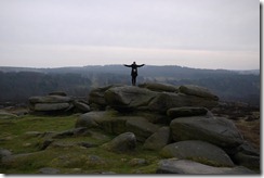 Me feeling free (and cold) atop a rocky outcrop in the Peaks District, England